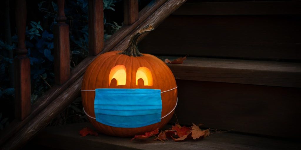 Lighted Jack-o-Lantern dressed up for Halloween with COVID Pande